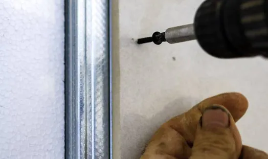 stock-photo-creation-plasterboard-wall-close-screwing-electric-screwdriver